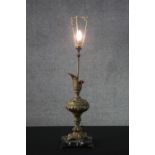 A large gilt spelter repousse design ewer table lamp mounted on a black and white marble base. H.