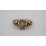 A 9ct yellow gold dress ring set with an oval mixed cut amethyst with an approximate carat weight of