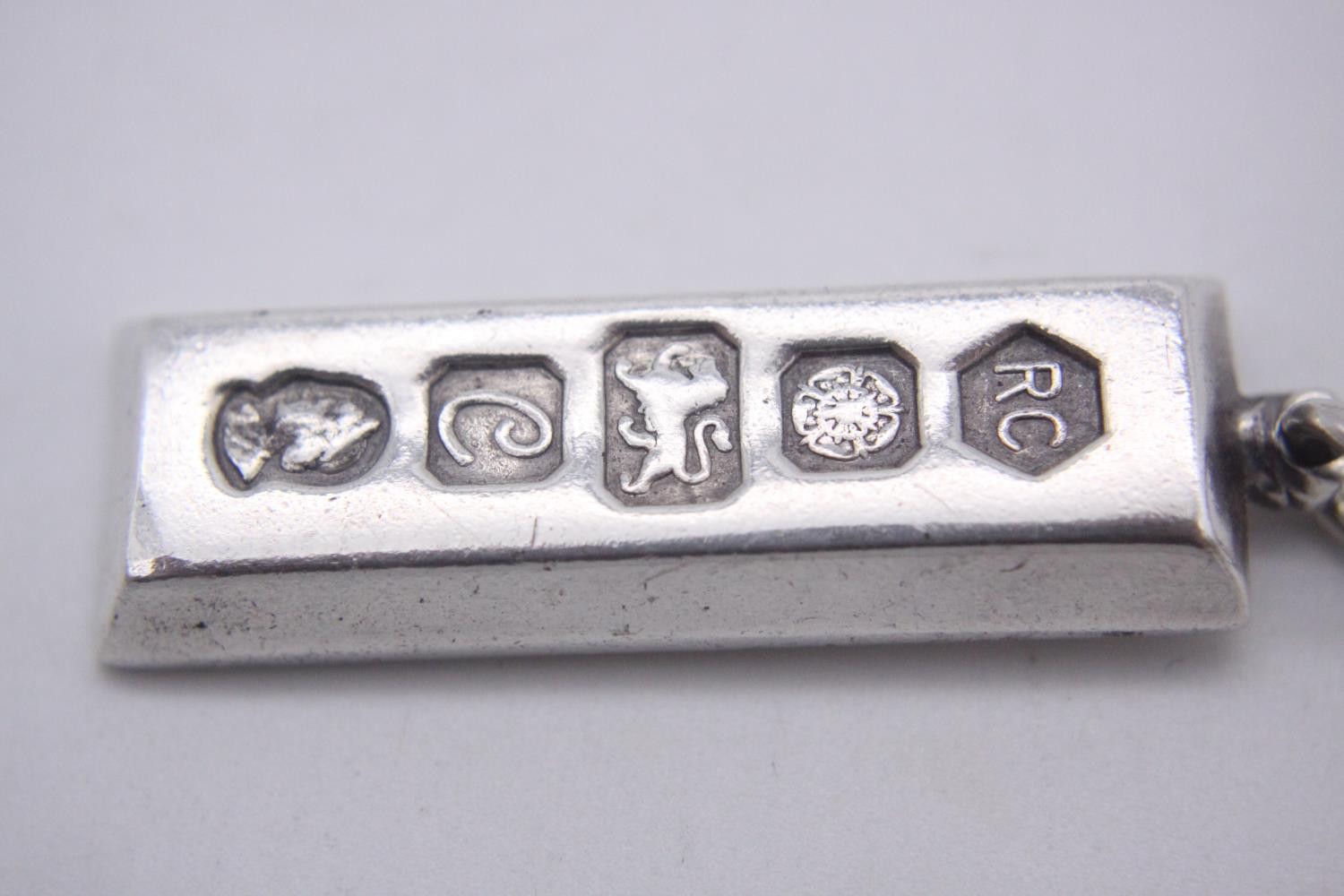 Three silver ingot pendants, each stamped to the front with a different set of hallmarks. Makers: - Image 2 of 10