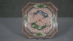A 20th century Chinese hand painted porcelain octagonal plate. Decorated with two dragons chasing