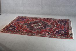 A red ground handmade Persian Hamadan rug. L.220 W.126CM