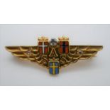 A Scandinavian Airlines 18 carat gold diamond and enamel brooch. The three country shields in