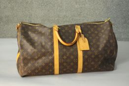 A Louis Vuitton "Keepall" 60, date code:MB4007 , Monogram canvas exterior with leather trim, dual