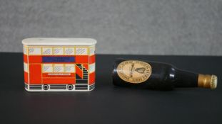 A Carlton Ware London bus Guinness ceramic money box along with a Guinness bottle design clothes
