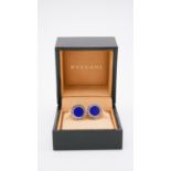 A boxed pair of Bulgari sterling silver and lapis cufflinks with engraved branding and whaleback