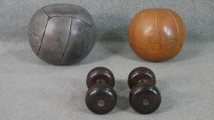Two leather medicine balls, including a grey leather example, and a tan leather ball marked 'Gronzig