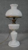 A Victorian moulded milk glass gadrooned design oil lamp, with milk glass shade, brass fittings