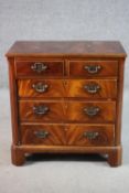 A Georgian style flame mahogany chest, with two short drawers over three long faux drawers