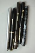 A collection of five 14 carat gold-nibbed fountain pens, including a Sheaffer brushed chrome