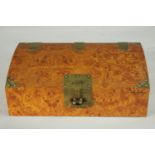 A Burr walnut veneer Chinese style jewellery box with brass fittings with padlock (no key), paper