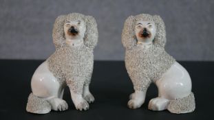 A pair of 19th century Staffordshire pottery poodles. H.13.5 W.10cm