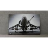 A large black and white photo on glass of a Harrier jump jet. H.08 W.120cm