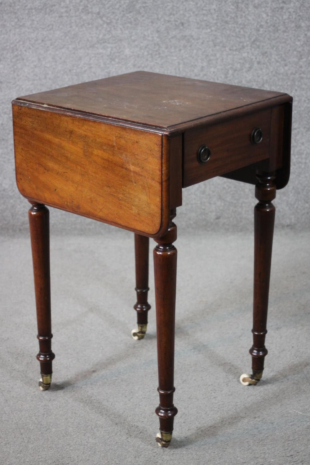 A Victorian mahogany work table, the drop leaf top with a moulded edge, over a single drawer, on