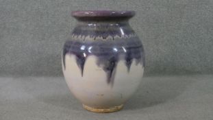 A large purple drip glaze on white ground art pottery vase. Impressed number to base. H.47 Diam.30cm
