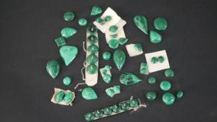 A collection of carved Malachite buttons, cabochons and various polished pieces.