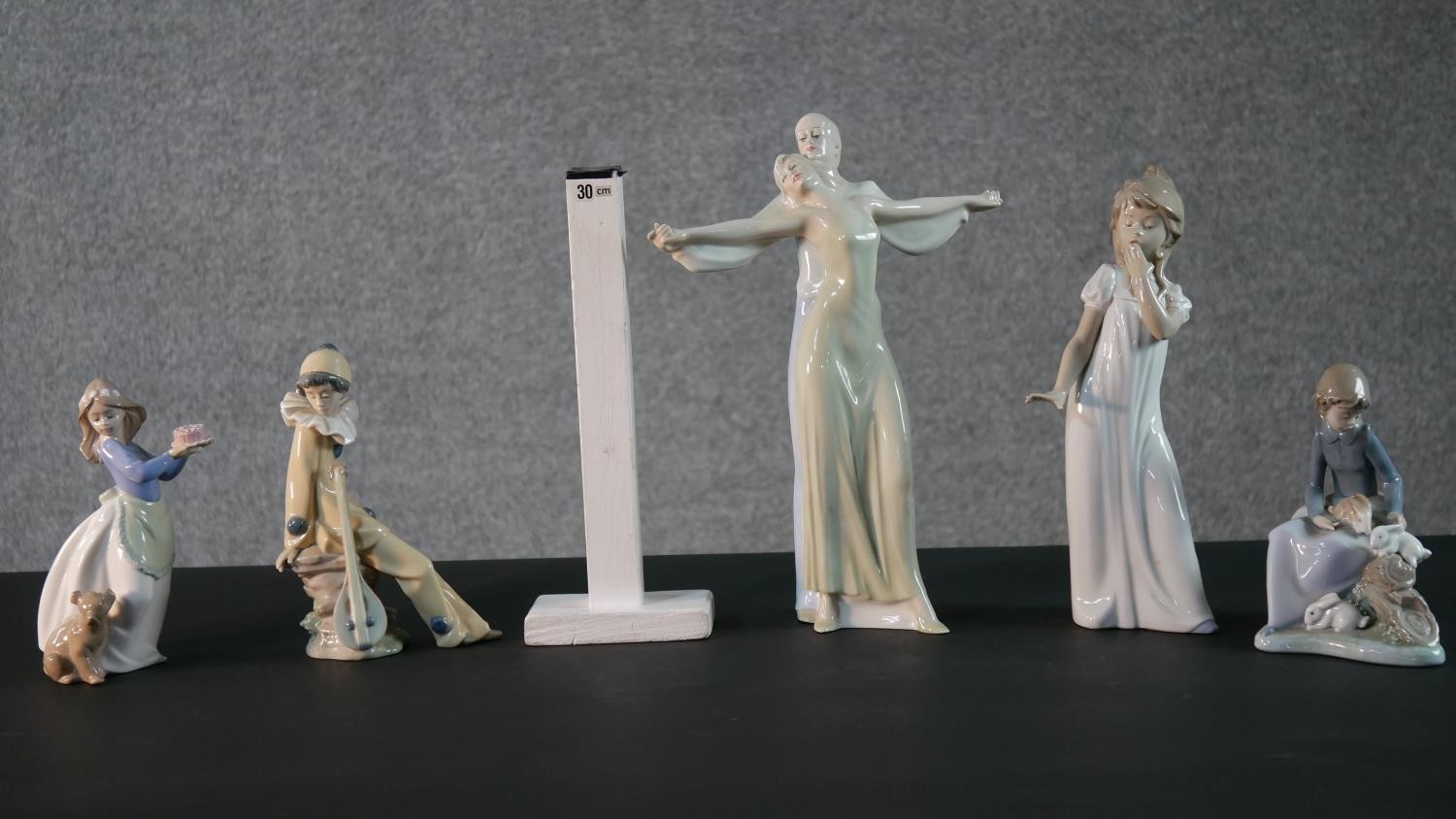 A collection of porcelain figures. Four Nao figures, a girl holding a cake with her dog , a clown, a - Image 2 of 13