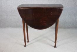 A drop leaf table, with an oval top, on pad feet. H.73 W.98 D.72cm.