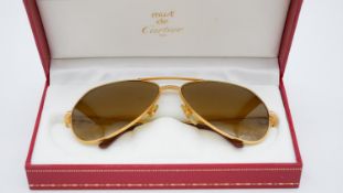 A red leather cased pair of vintage Must de Cartier bicolour gold plated 140 aviator sunglasses,