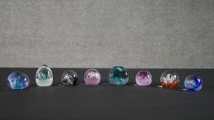 A collection of eight limited edition Caithness lamp work glass paperweights. Stamped to the base.