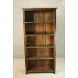 A set of dark stained wood bookshelves, containing five shelves, on block feet. H.180 W.84 D.28cm.