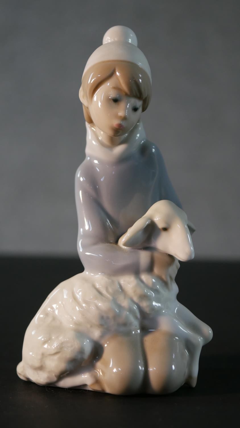 A collection of five Lladro porcelain figures, including a clown and puppy, girl with a lamb, boy in - Image 3 of 14
