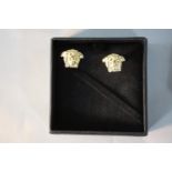 A boxed pair of gold metal Versace medusa head cufflinks. H.9 W.9cm (box)