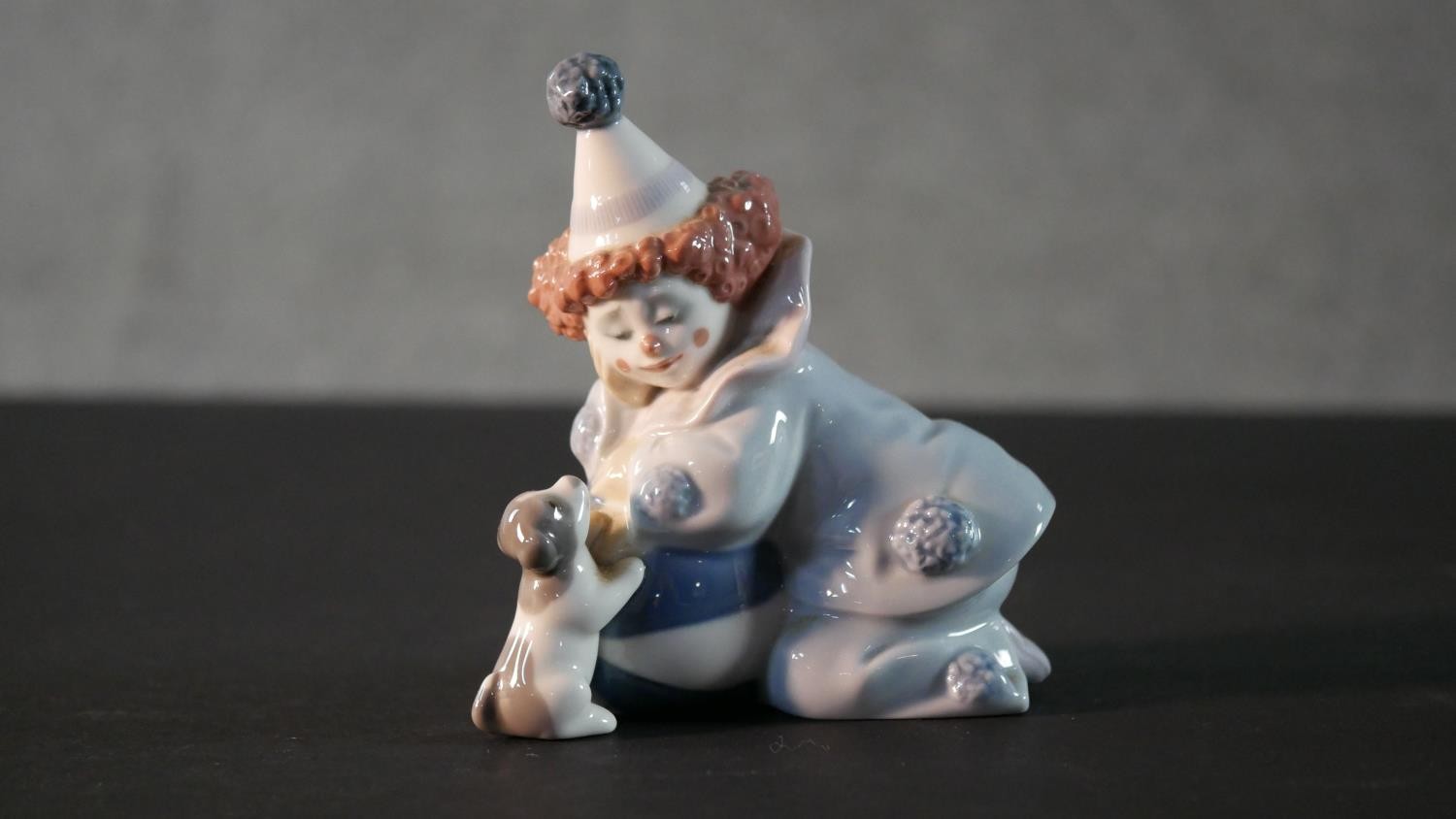 A collection of five Lladro porcelain figures, including a clown and puppy, girl with a lamb, boy in - Image 7 of 14