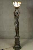 A very large bronze effect resin Greek goddess form floor lamp on foliate design column base with