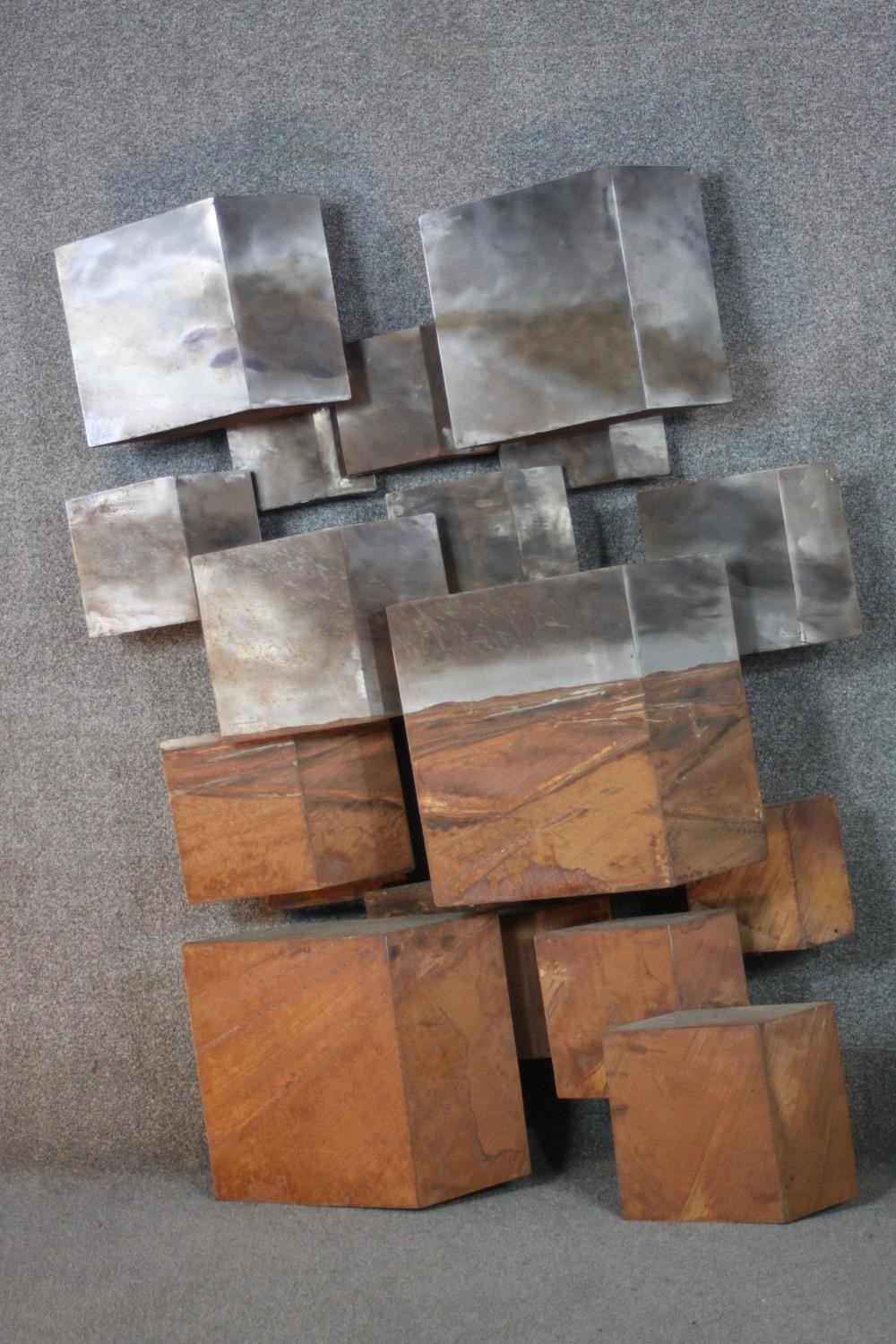 Stevens Dossou-Yovo (French b.1969) An abstract brushed raw and oxidized steel geometric sculpture