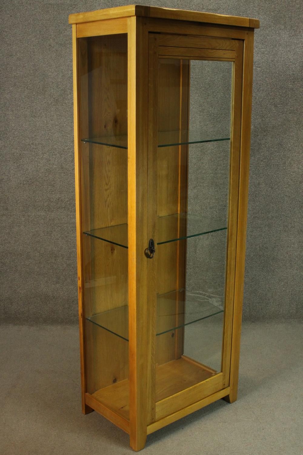 A contemporary honey oak display cabinet, with glazed door and sides, enclosing glass shelves. H.180 - Image 2 of 9