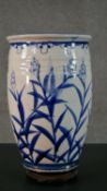 A large oriental blue and white ceramic stylised floral design vase. H.36 Diam.21cm (inc. stand)