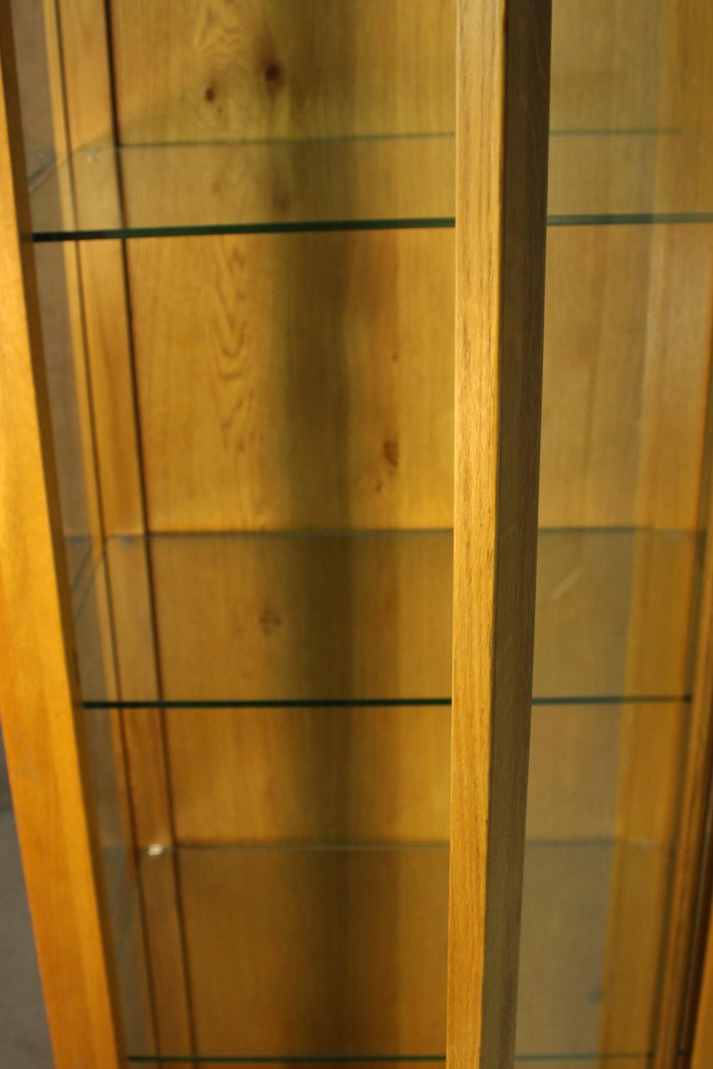A contemporary honey oak display cabinet, with glazed door and sides, enclosing glass shelves. H.180 - Image 3 of 9