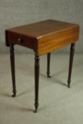 A Victorian mahogany work table with drop leaves and an end drawer, on turned legs. H.72 W.67 D.