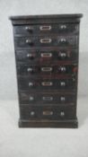 A late Victorian ebonised pine collectors chest, the seven drawers with turned knob handles, on a