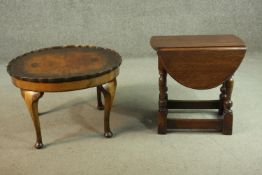 A 1930's figured walnut coffee table, with a circular pie crust top on cabriole legs, together
