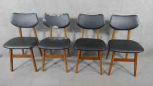 A set of four Scandinavian style teak dining chairs, circa 1960's, with faux leather upholstered