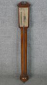 A George III mahogany stick barometer, with a broken arch, the silvered gauge inscribed Ware