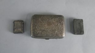 A silver vesta case, an engraved foliate design silver cigarette case and a pewter snuff box.