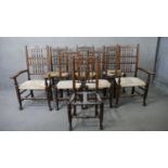 A set of eight Lancashire style oak spindle back dining chairs with woven seats on stretchered pad