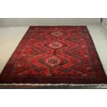 A red ground handmade Persian Lorestan carpet. L.256 W.175cm.