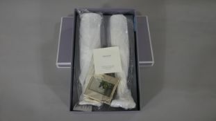 A boxed set of Vera Wang for Wedgwood Love Knots Toasting Flutes with small photo frame and