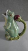 A Majolica glazed pitcher in the form of a gaping frog with waterlily bud handle, stamped to the
