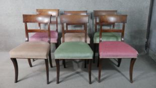 Dining chairs, a set of six early 19th century mahogany on sabre supports.