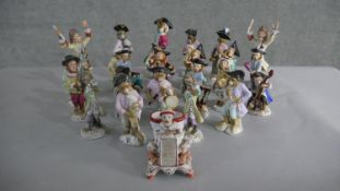 A set of twenty seven 19th century continental hand painted porcelain figures of monkey musicians,