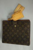 A Louis Vuitton monogrammed canvas Filofax cover with luggage tags. H.23 W.19cm.