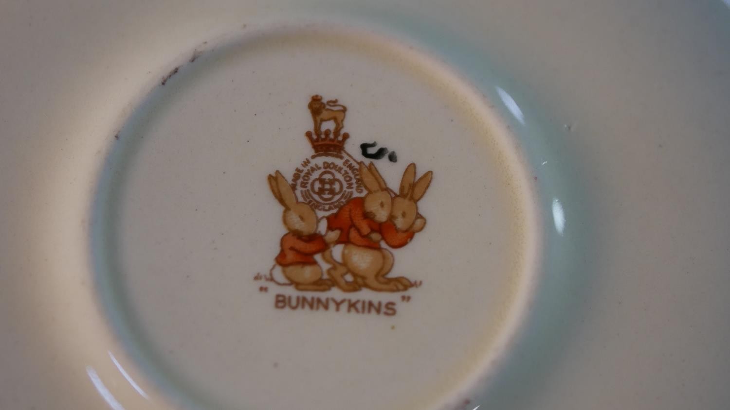 A collection of Royal Doulton Bunnykins pattern child's crockery, includes three cups, a moneybox, a - Image 16 of 16