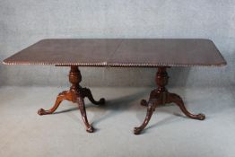 A George II style mahogany pedestal dining table, the top with a gadrooned edge, on tripod