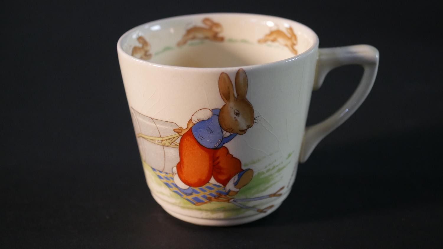 A collection of Royal Doulton Bunnykins pattern child's crockery, includes three cups, a moneybox, a - Image 4 of 16