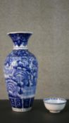 A large Oriental blue and white hand painted ceramic vase decorated with peonies along with a