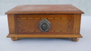 An Edwardian walnut desktop drawer, line inlaid, with a circular ring handle, on bun feet. H.4 W.